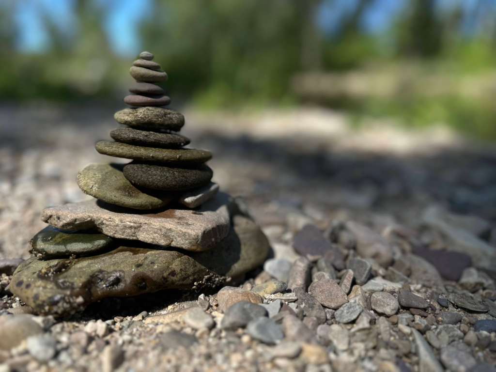 A stack of balanced river rocks placed by Sue Evergreen in a post about removing rocks for mindfulness.