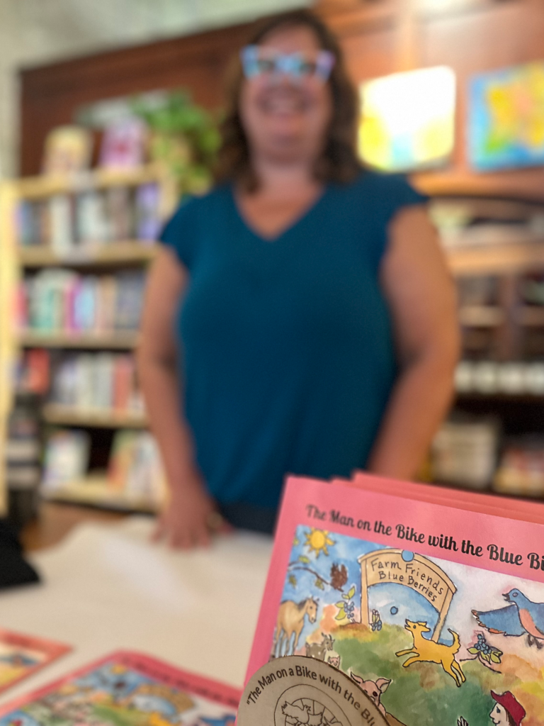 Image of author Natalia Lee with her children's book at an author event. Permission to use granted to Onward Sister.
