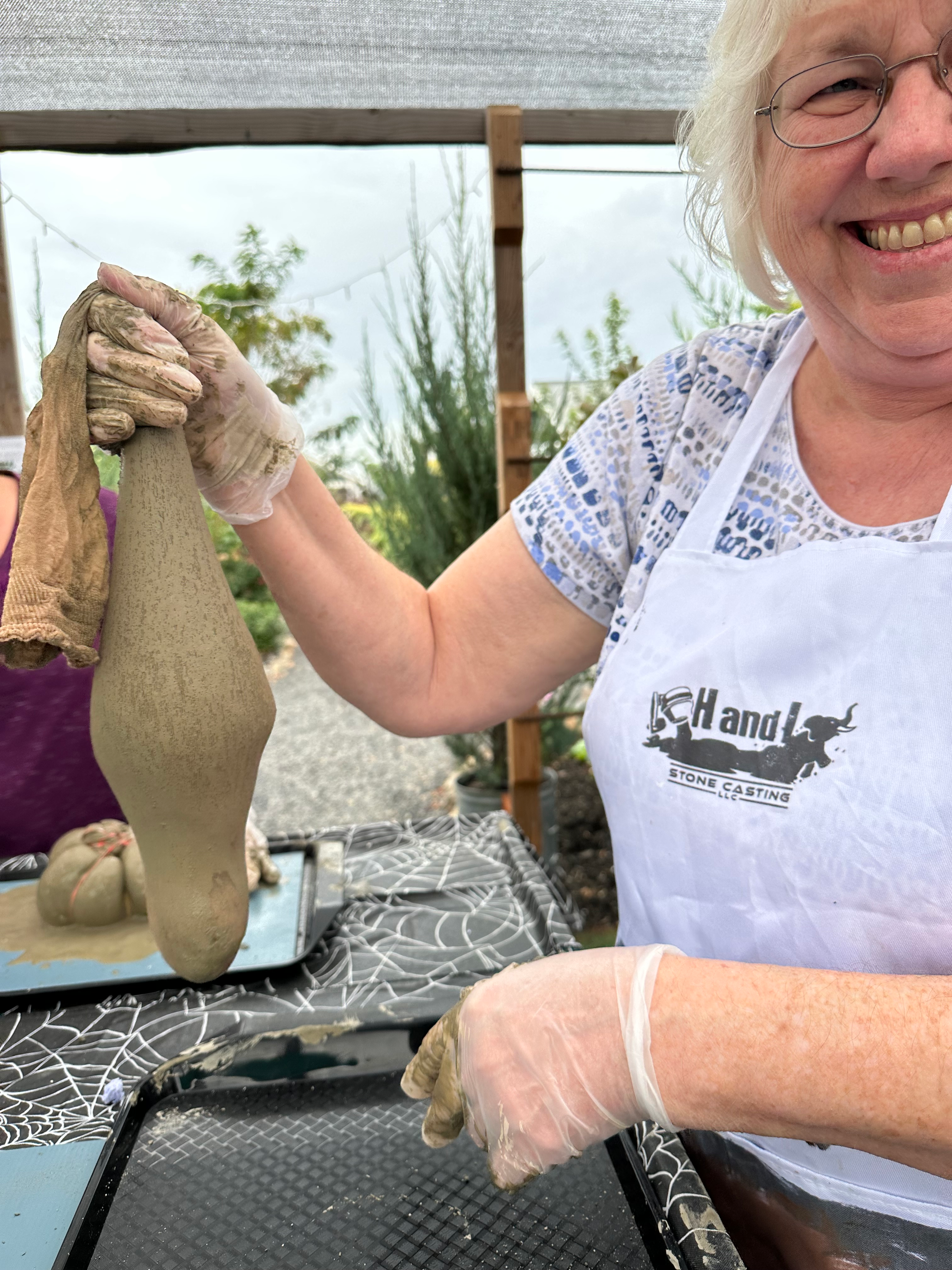 A photo of Sandra laughing while making concrete ghosts with her daughters. Image taken and copyrighted by Sue Evergreen.