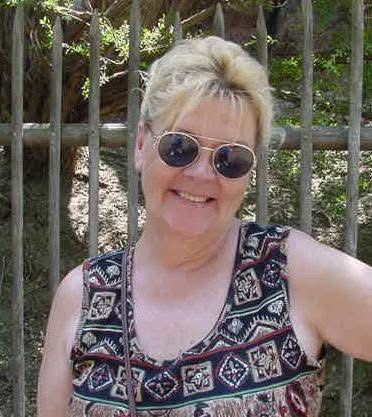 A current picture of Suzanne outside, wearing a colorful tank top and sunglasses. Image permission given to Onward Sister by Suzanne Wright.